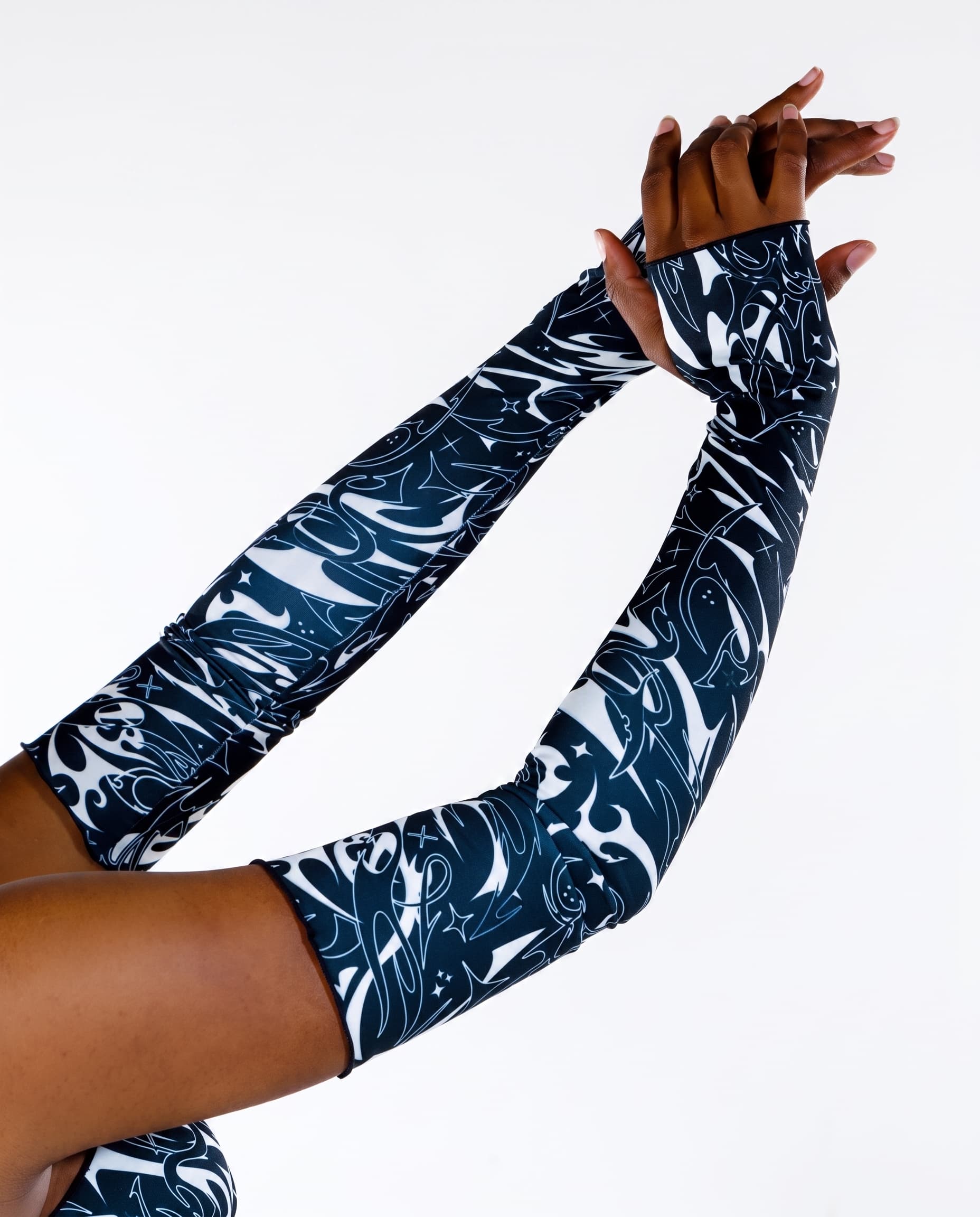 BLVDE Chilled Out Arm Sleeves, close-up of black and white print on raised arms with hands clasped