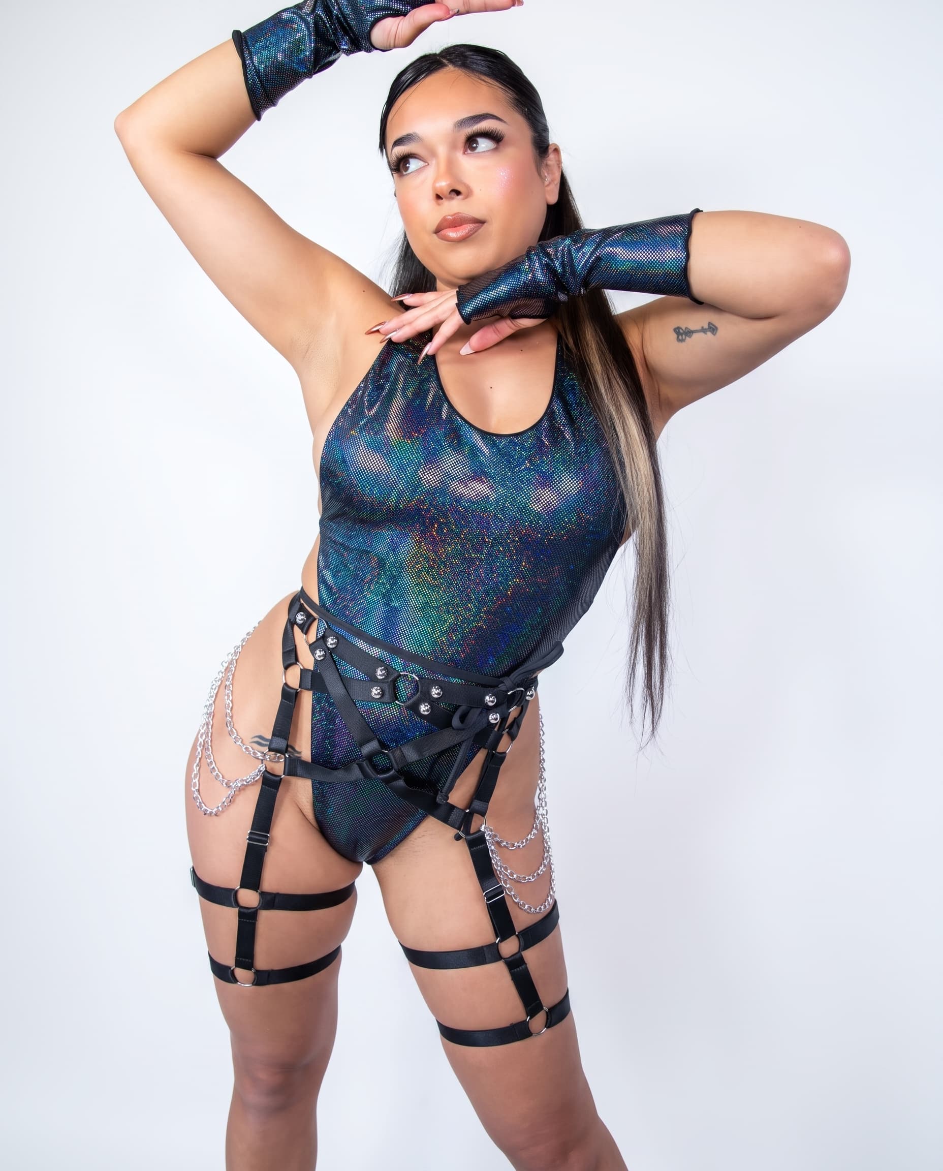 Midnight Temptation Cheeky One Piece, front view with iridescent fabric and black harness layered over hips