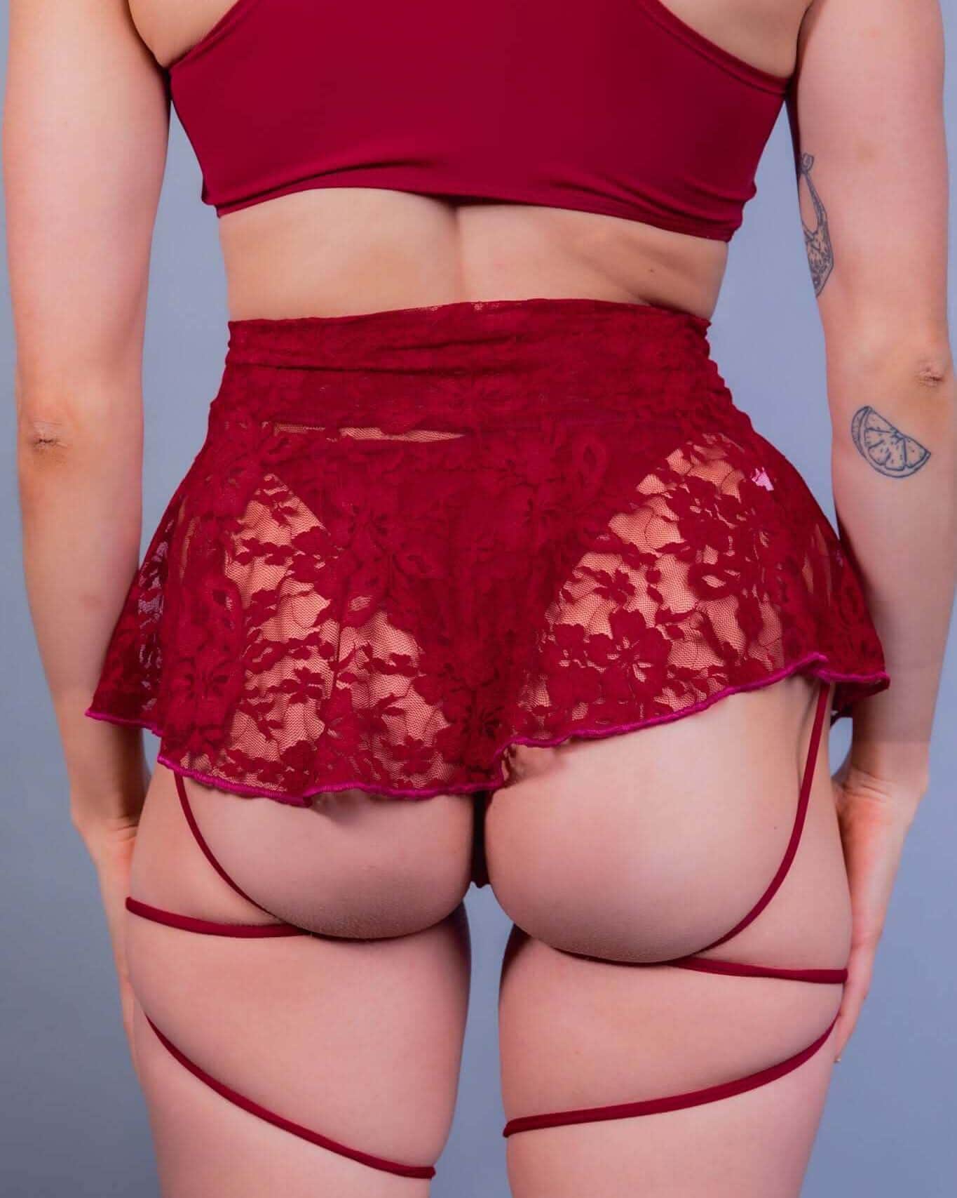 Back view of scarlet lace rave skirt with flirty skater silhouette and matching festival outfit accessories