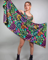 Woman showcasing a vibrant floral pashmina scarf, perfect for elevating rave outfits at festivals.