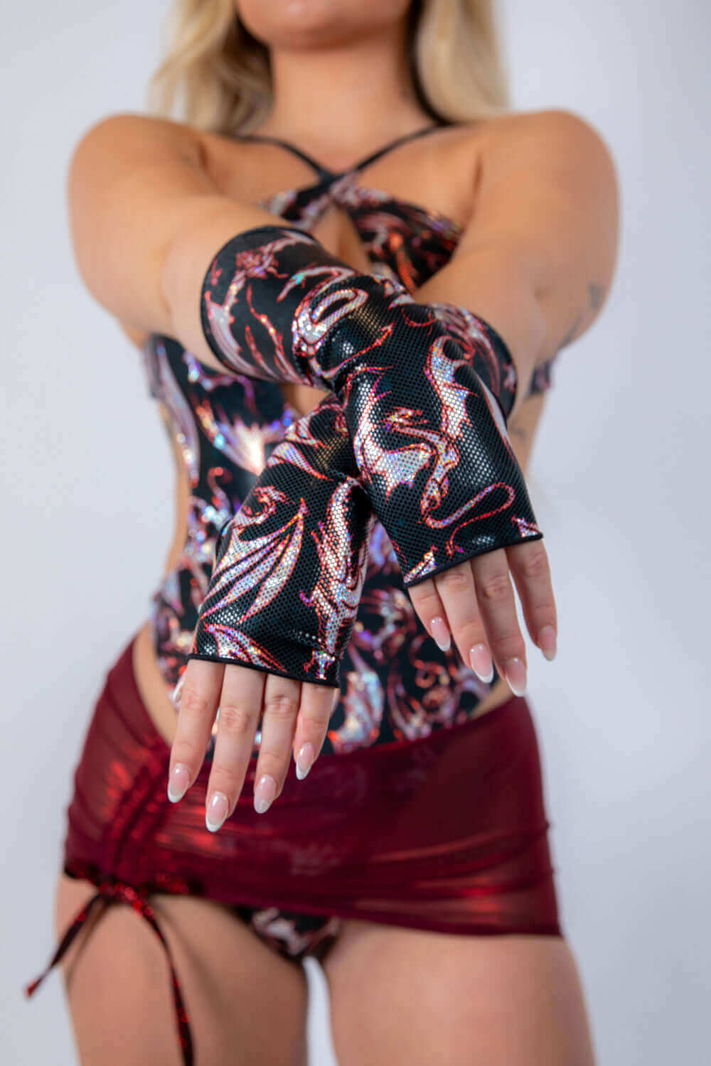 Woman modeling a stylish rave outfit with fingerless gloves, perfect for EDC 2025.