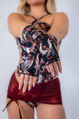 Woman modeling a stylish rave outfit with fingerless gloves, perfect for EDC 2025.
