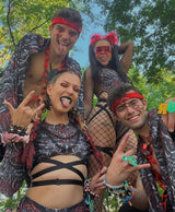 group of ravers wearing matching rave outfits at a music festival exuding rave fam energy
