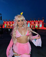 rave girl in pink and white rave outfit is in a rave wonderland at edc las vegas
