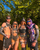 group of ravers all in matching chrome metallic rave outfits exude festival energy at a music festival