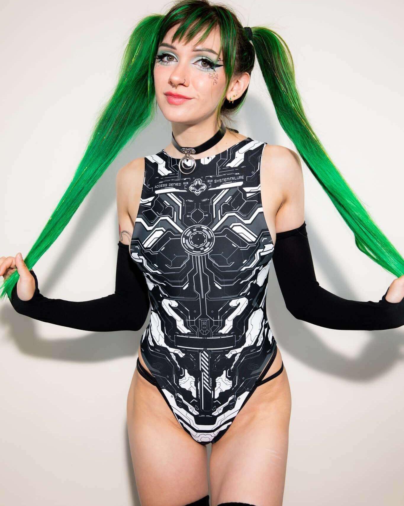 Two friends in futuristic, black and white, cyber-themed rave outfits, standing side by side and smiling.