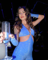 rave girl wearing sparkly blue outfit in the club on new years eve