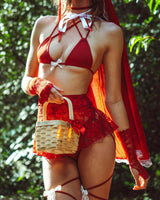 raver wearing scarlet and lace festival outfit holding a basket and white bow details