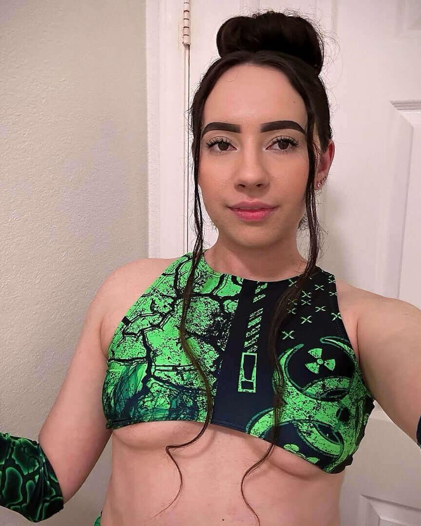 Model showcasing the green and black Toxic Teaser Top, perfect for rave outfits, featuring a bold design and recycled materials.