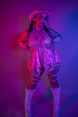 rave cowgirl holographic pink model wearing a strong pose in photoshoot blacklight