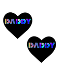 Heart-shaped black nipple cover pasties with holographic 'DADDY' lettering, ideal for rave outfits and bold style.