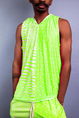 Model in a vibrant green sleeveless hooded top and matching shorts from Freedom Rave Wear, featuring psychedelic patterns. - 2