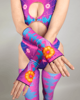 Close-up of neon pink and blue rave wear set with sunflower accents, for a standout festival look.