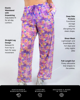 Duckies Mesh Lucy Pants in vibrant purple, yellow, and pink print, featuring wide-leg design, lightweight mesh, and elastic waistband.
