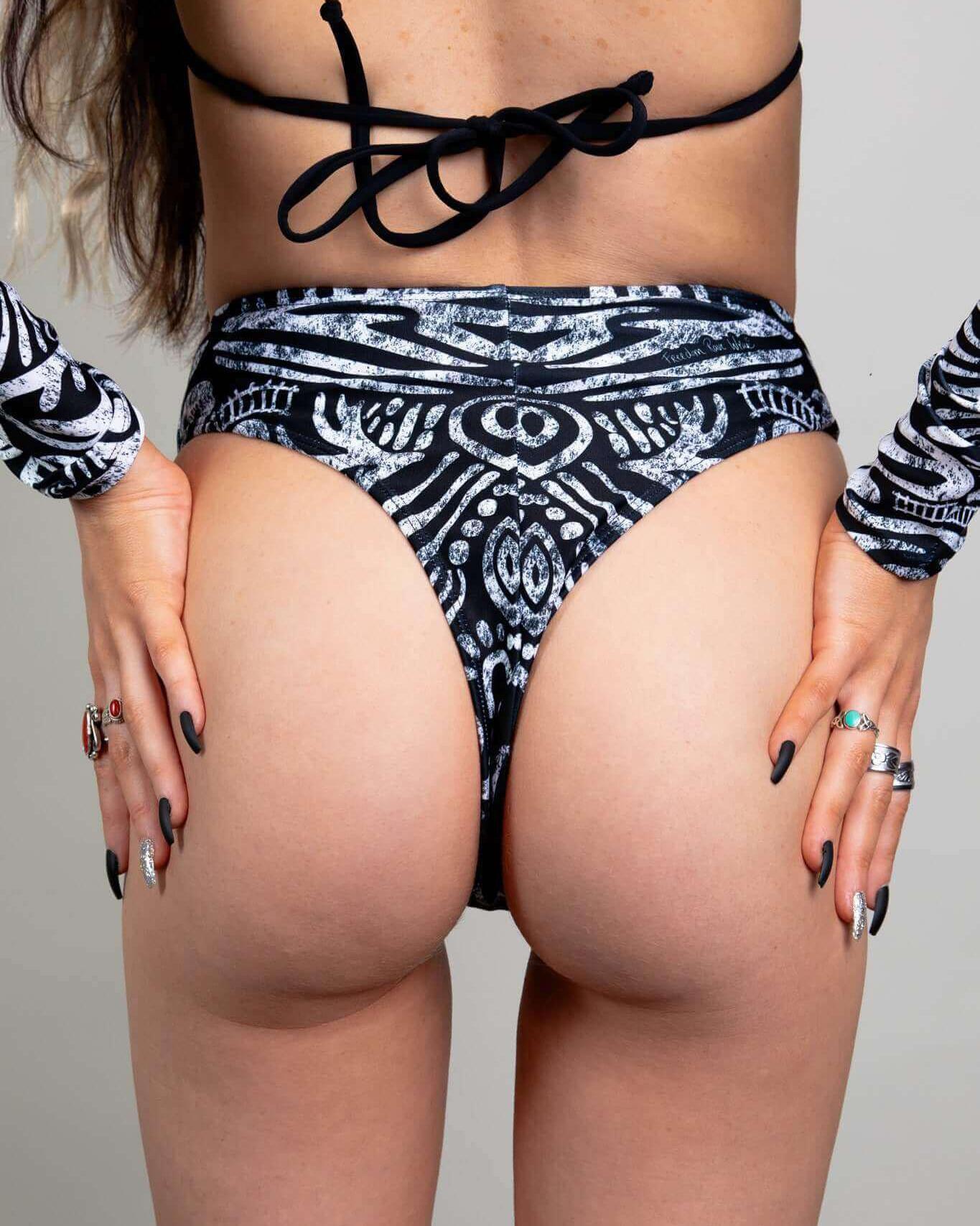 Model showcasing the Archaic High Waisted Thong, featuring a bold design and extra cheeky cut, perfect for rave outfits.