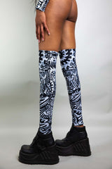 An up close photo of a girl's legs. She is wearing black and white tribal printed leg sleeves that go just above the knee.