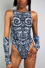 An up close photo of a girl wearing a black and white tribal printed bodysuit with matching arm sleeves.