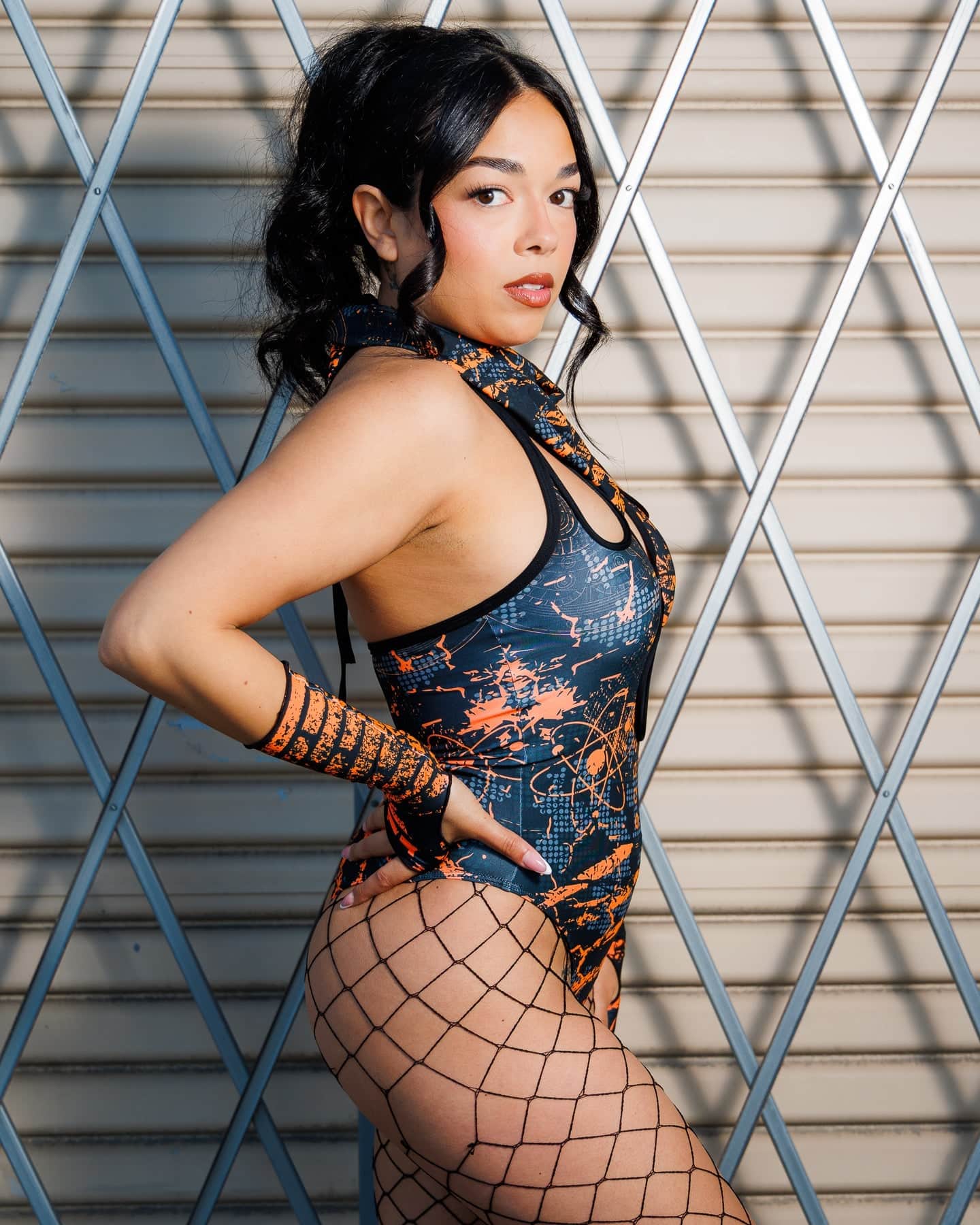 Model wearing Atomic Bandana in orange and black tones, styled as a headwrap with edgy post-apocalyptic flair, perfect for festivals.