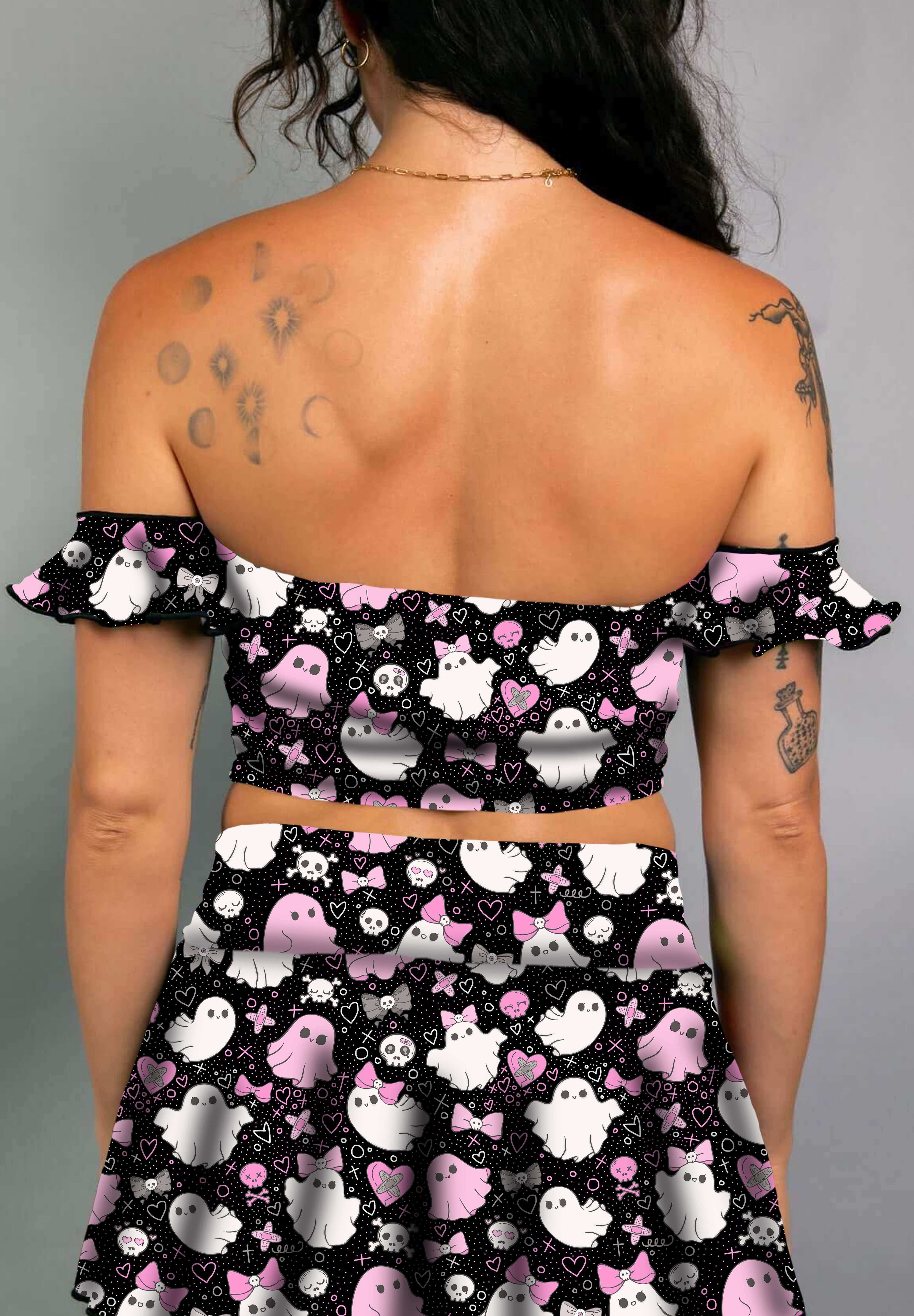 Model in a black off-shoulder bardot top with pink and white spooky ghost print, paired with matching skirt