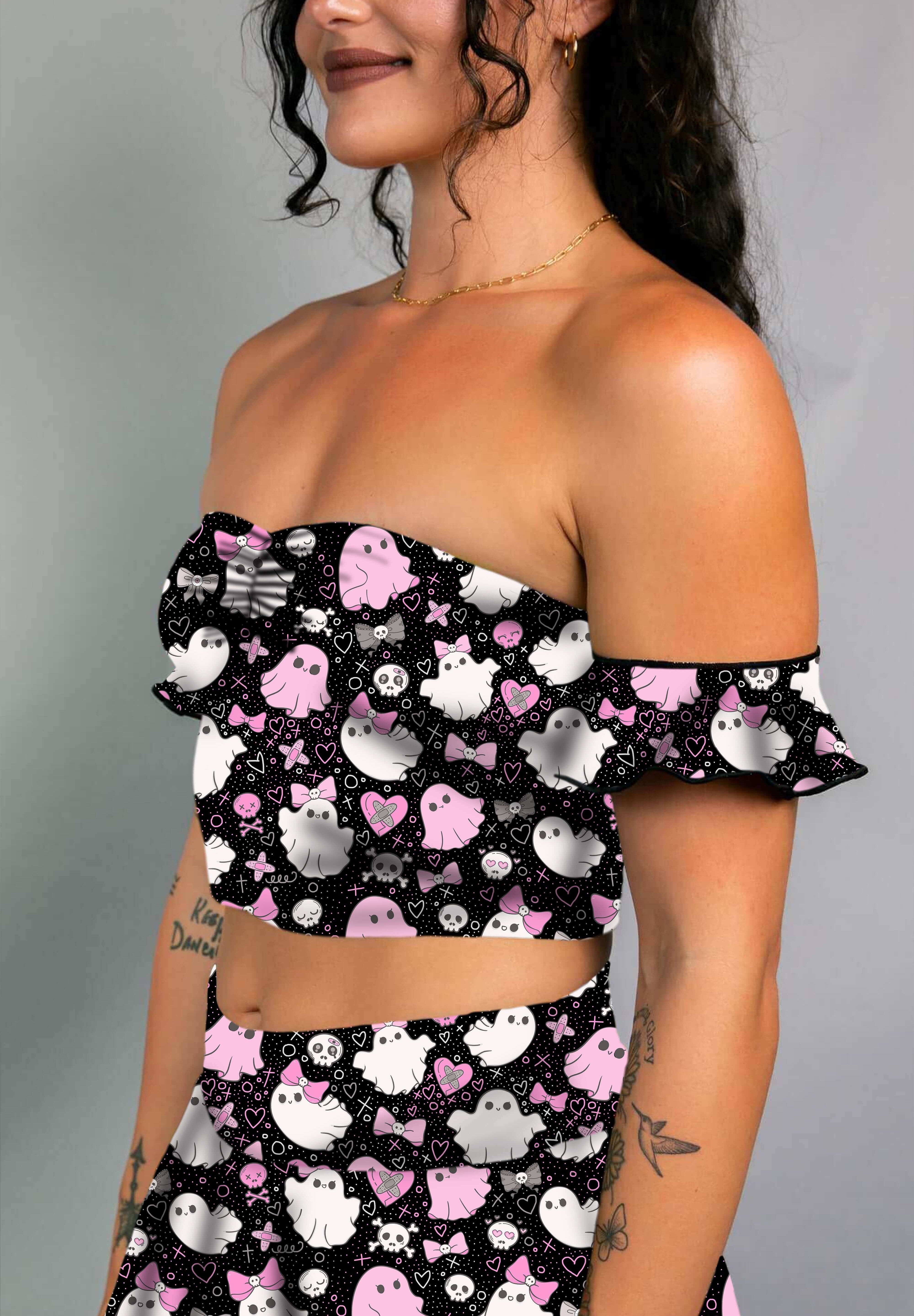 Model in a black off-shoulder bardot top with pink and white spooky ghost print, paired with matching skirt