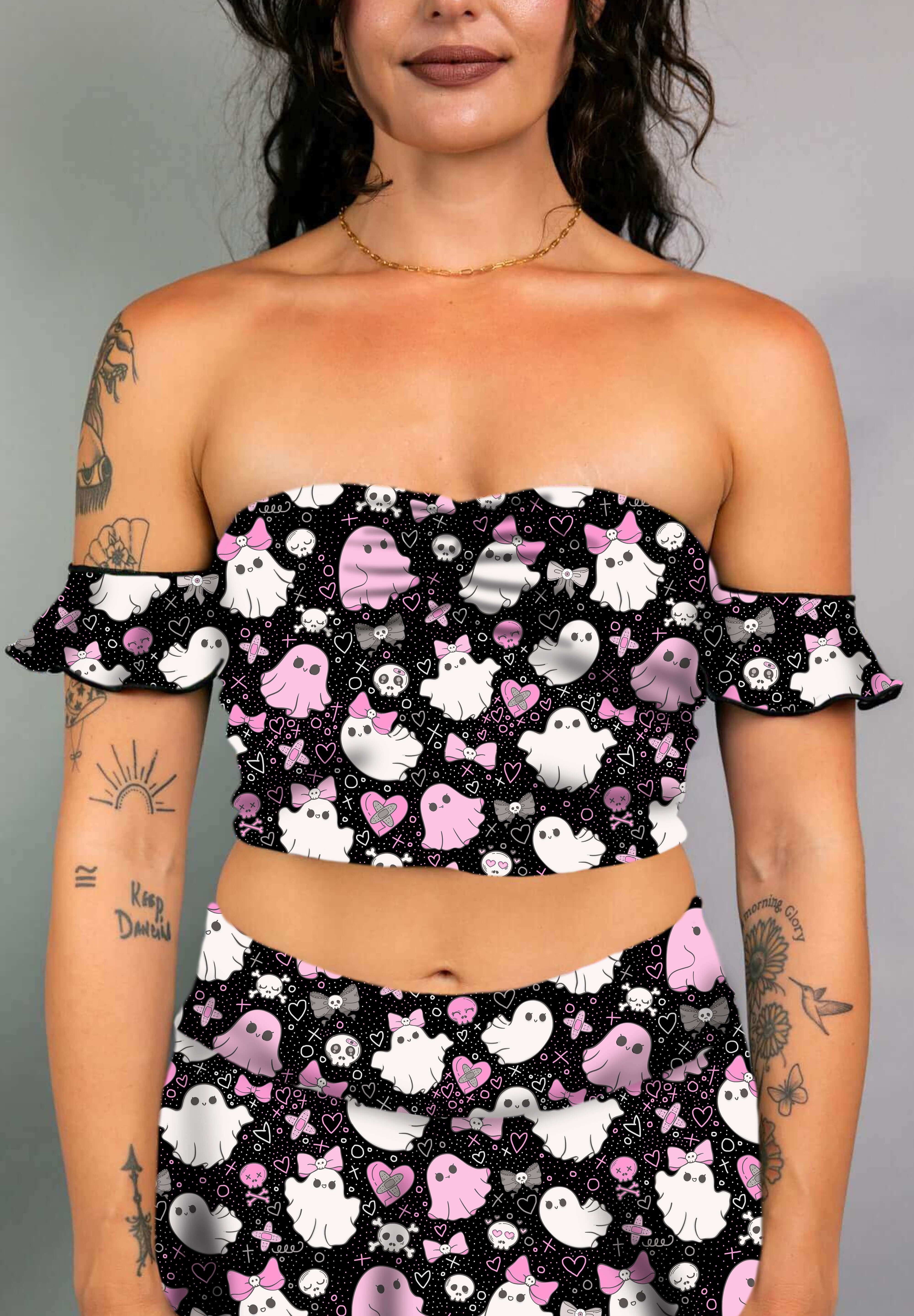 Model in a black off-shoulder bardot top with pink and white spooky ghost print, paired with matching skirt.