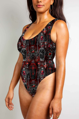 Red and black gothic bodysuit with coffin and skull motifs, featuring bold, dark, vampiric themes.