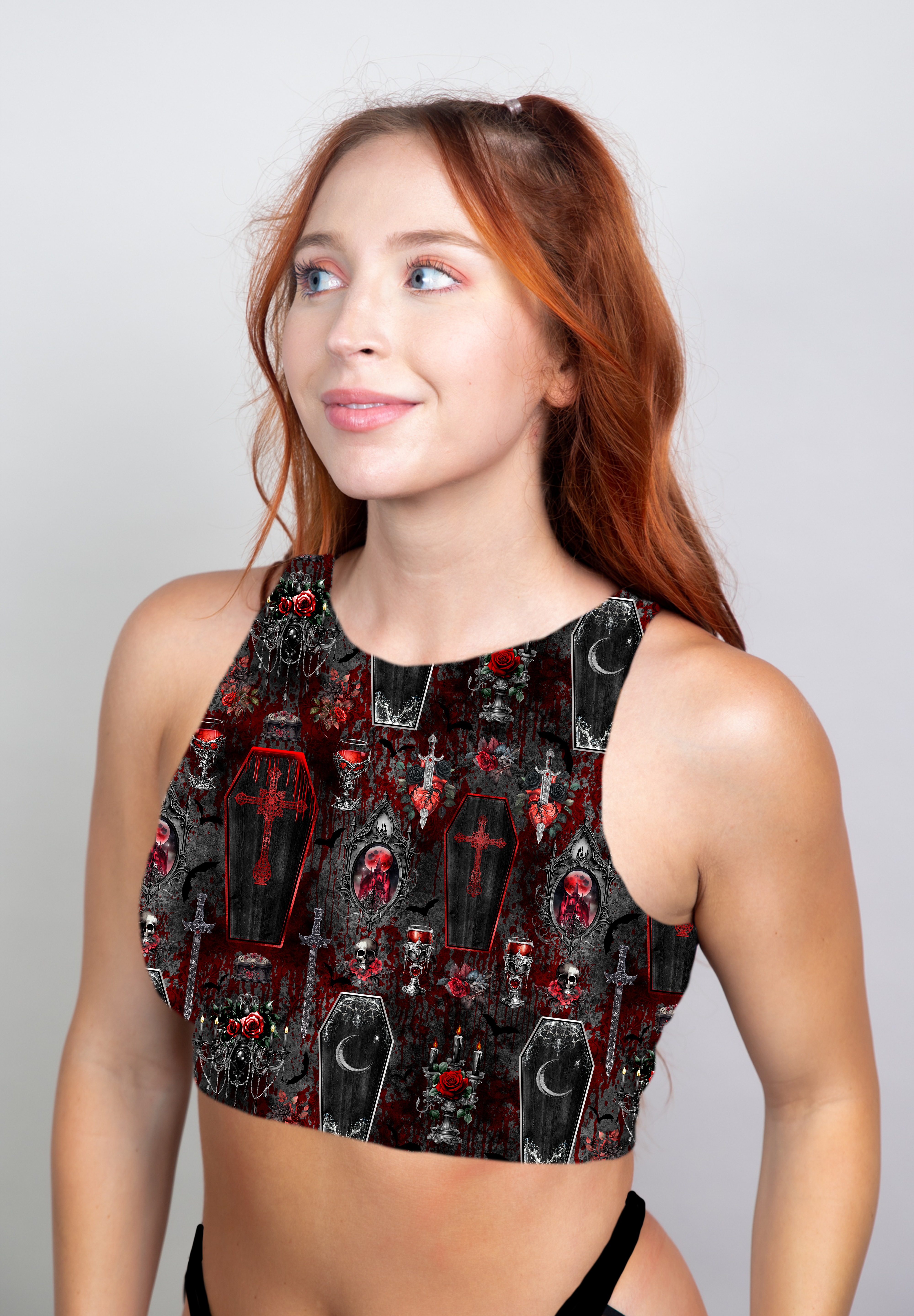 A dark gothic crop top adorned with red and black coffin and skull patterns, blending vampiric allure and modern style.