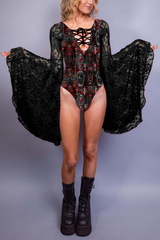 Black and red bodysuit featuring gothic coffin and cross designs, paired with lace sleeves for an ethereal yet edgy look.