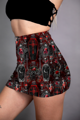 A mini skirt featuring a striking red and black coffin print, with gothic and vampire-inspired motifs throughout.
