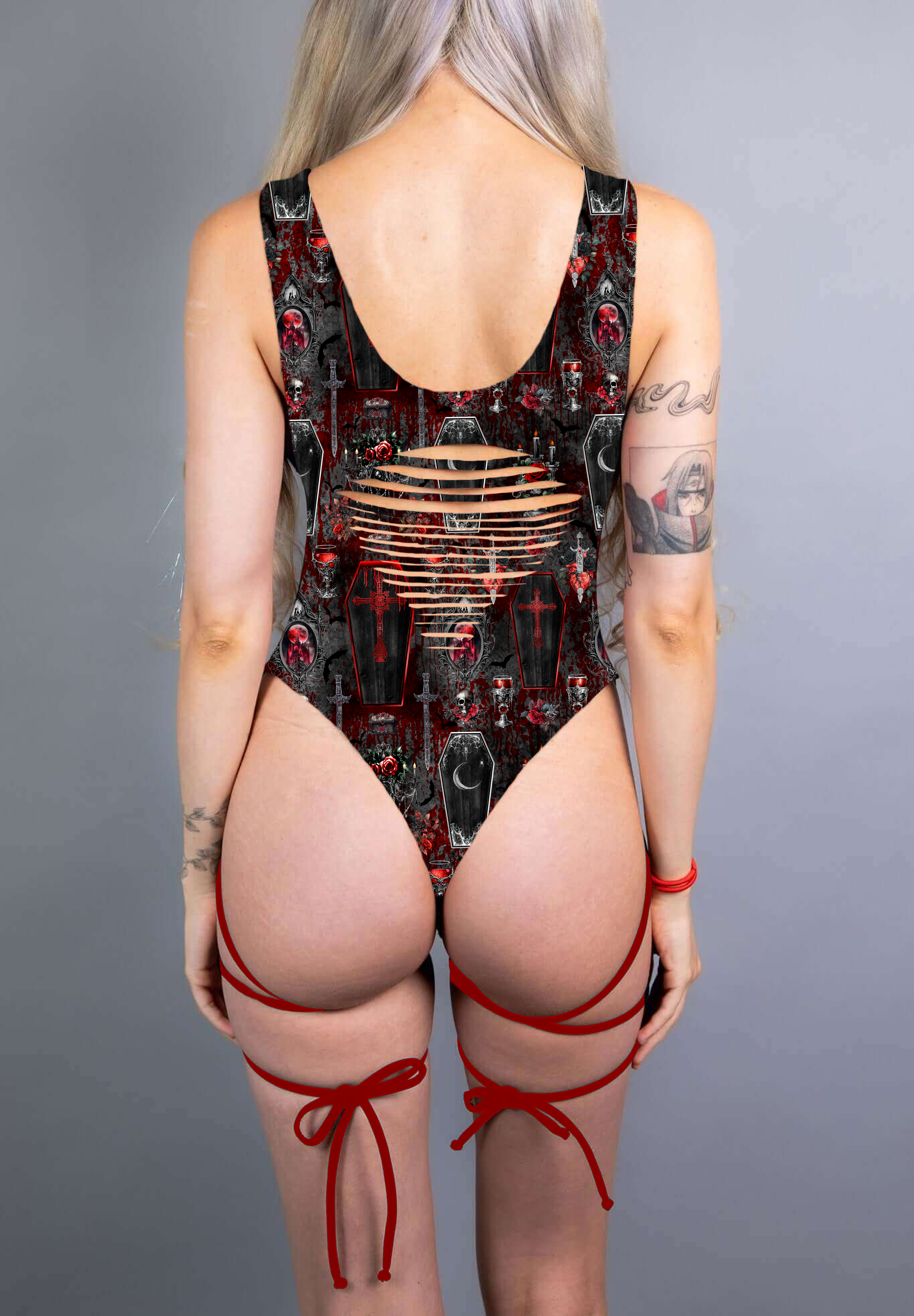  A gothic bodysuit with revealing slits and bold red straps, complemented by coffin and cross patterns in deep red and black.