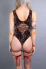  A gothic bodysuit with revealing slits and bold red straps, complemented by coffin and cross patterns in deep red and black.