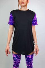 Model wearing Freedom Rave Wear black t-shirt with purple dinosaur print sleeves and matching thigh-high leg sleeves, ideal for raves.