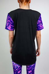 Back view of Baby Steps unisex t-shirt featuring black base and purple dinosaur fossil sleeves, perfect for rave outfits.