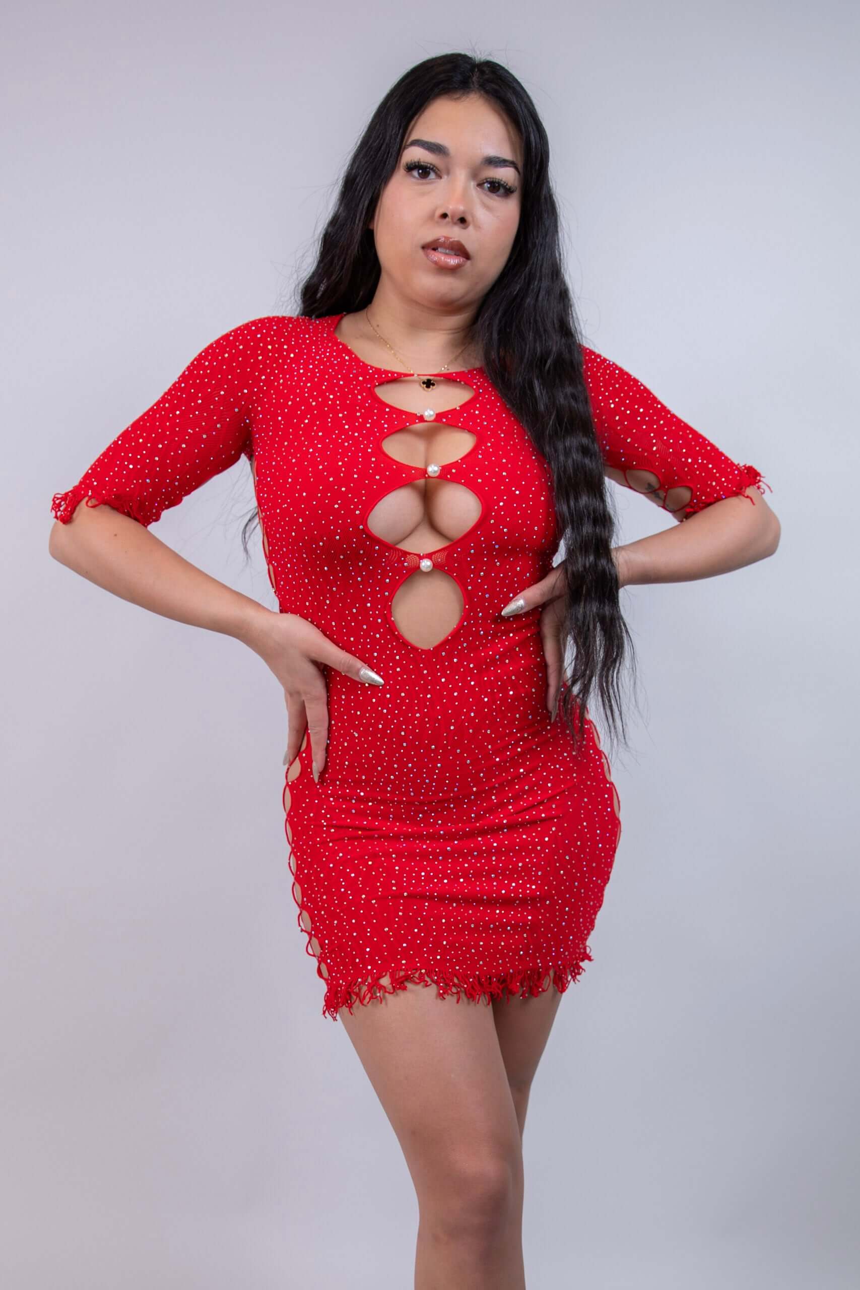 Model in a red rhinestone bodycon dress with side and front cutouts, perfect for rave outfits and party wear.