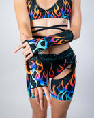 Model showcasing Blaze Gloves with flame and galaxy print, perfect for rave outfits and energetic style.