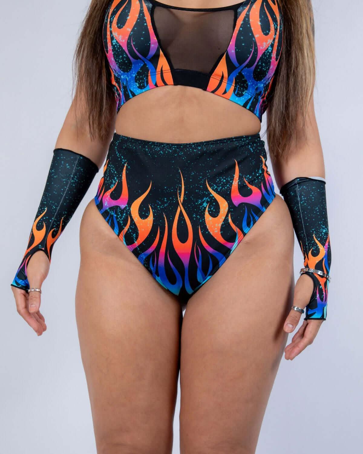 Model wearing Blaze High Waisted Bikini Bottoms with flame print and matching arm sleeves, perfect for rave outfits.
