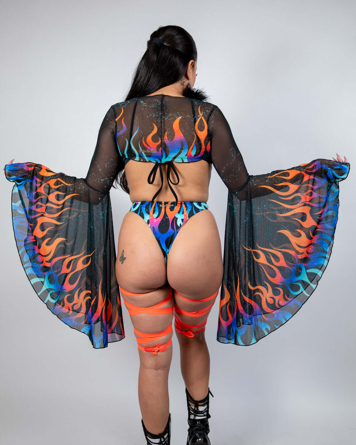 Model wears Blaze Mesh Bell Sleeves with flame print in a bold rave outfit, perfect for festivals and vibrant looks.