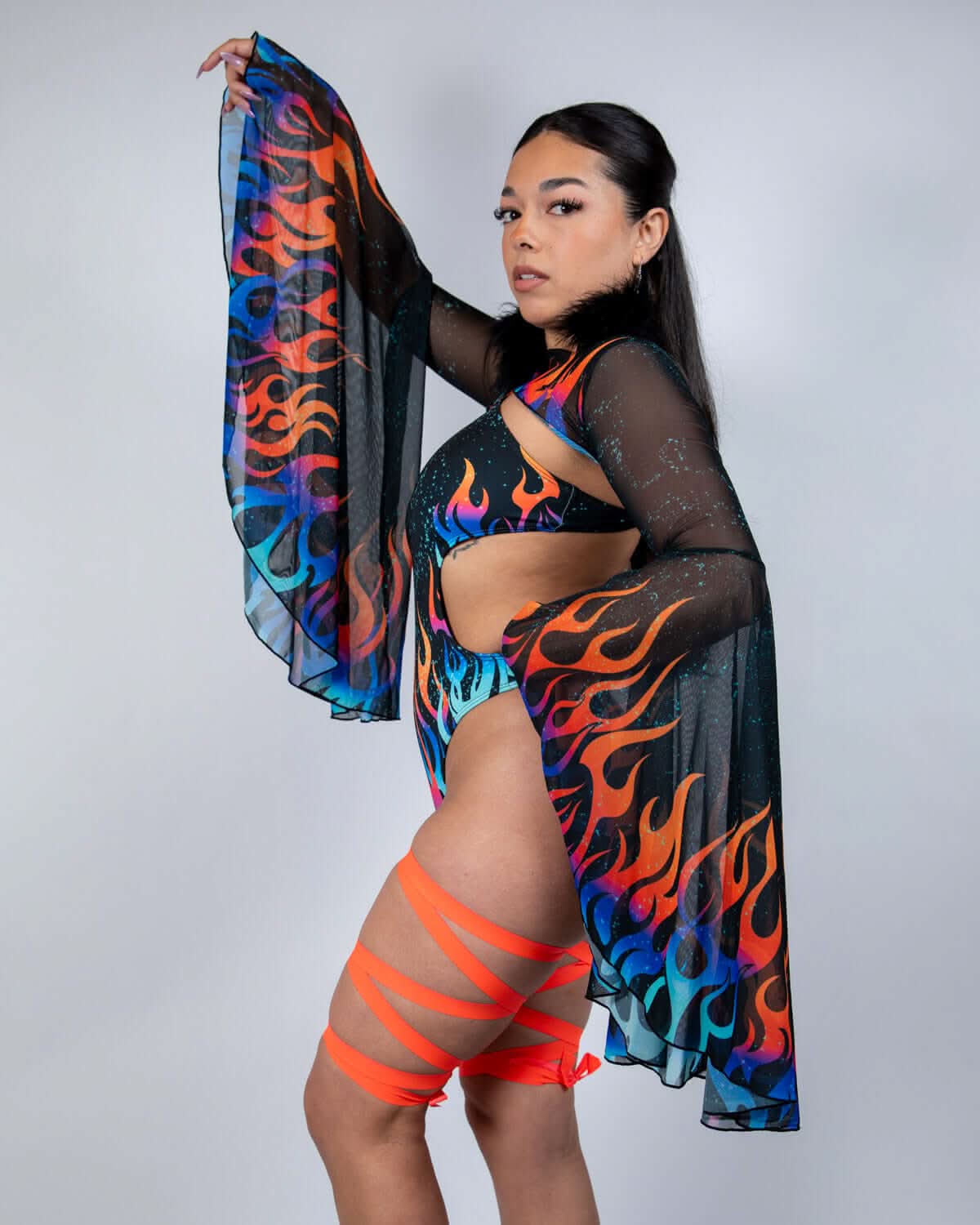 Woman in Blaze Mesh Bell Sleeves with flame print, styled for rave outfits and festivals.