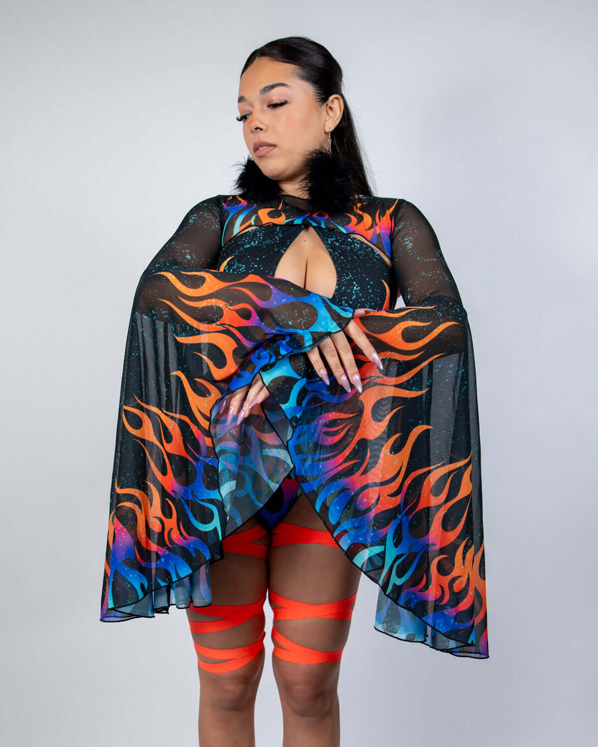Woman wearing Blaze Mesh Bell Sleeves with flame print, showcasing a dramatic rave outfit.
