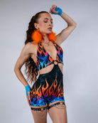 Woman in a fiery Blaze Romper featuring a plunging halter neckline and celestial flame print, ideal for rave outfits.
