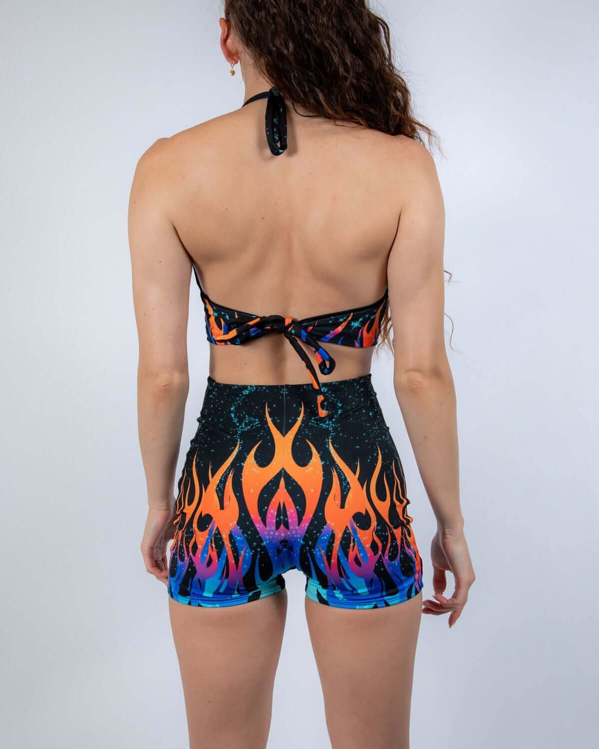 Back view of the Blaze Romper showcasing its fiery print and halter neckline, ideal for rave outfits.