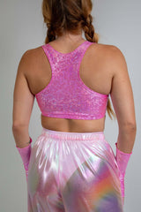 Model wearing a Bubble Gum Holo V Free Top, back view showcasing shiny pink holographic fabric with racerback straps, perfect for festival outfits.