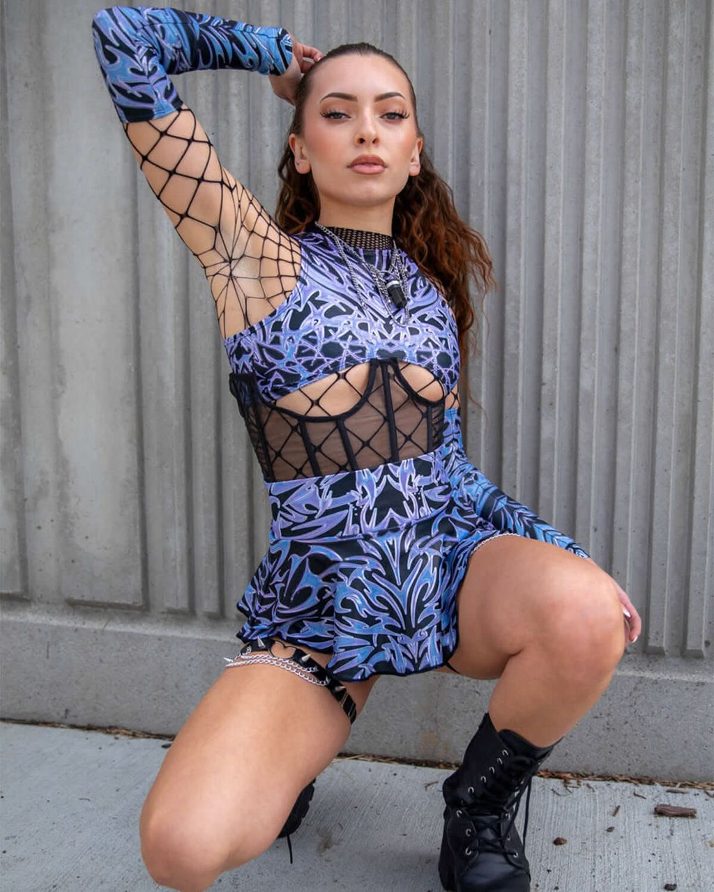 Model wearing Chromium Micro Skater Skirt, showcasing edgy street style combined with cyber sigalism graphic design.