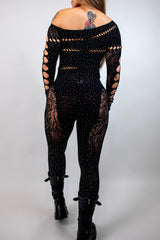 Off the shoulder black rhinestone jumpsuit with cutouts, ideal for bold rave outfits and stylish events.