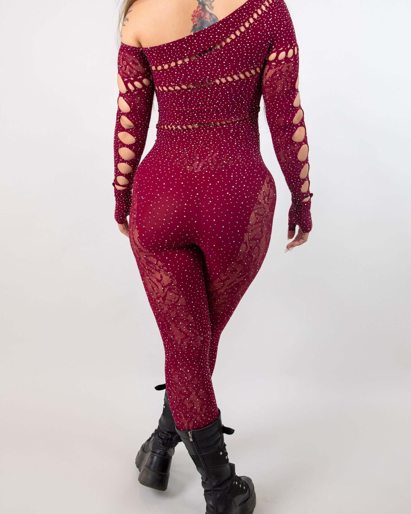 Back view of the burgundy Camilla Rhinestone Off the Shoulder Jumpsuit, showcasing its fishnet design and stylish cut-outs.