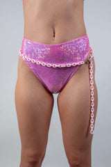 High-waisted pink bikini bottom styled with a light pink chain belt, perfect for rave outfits and summer fashion.