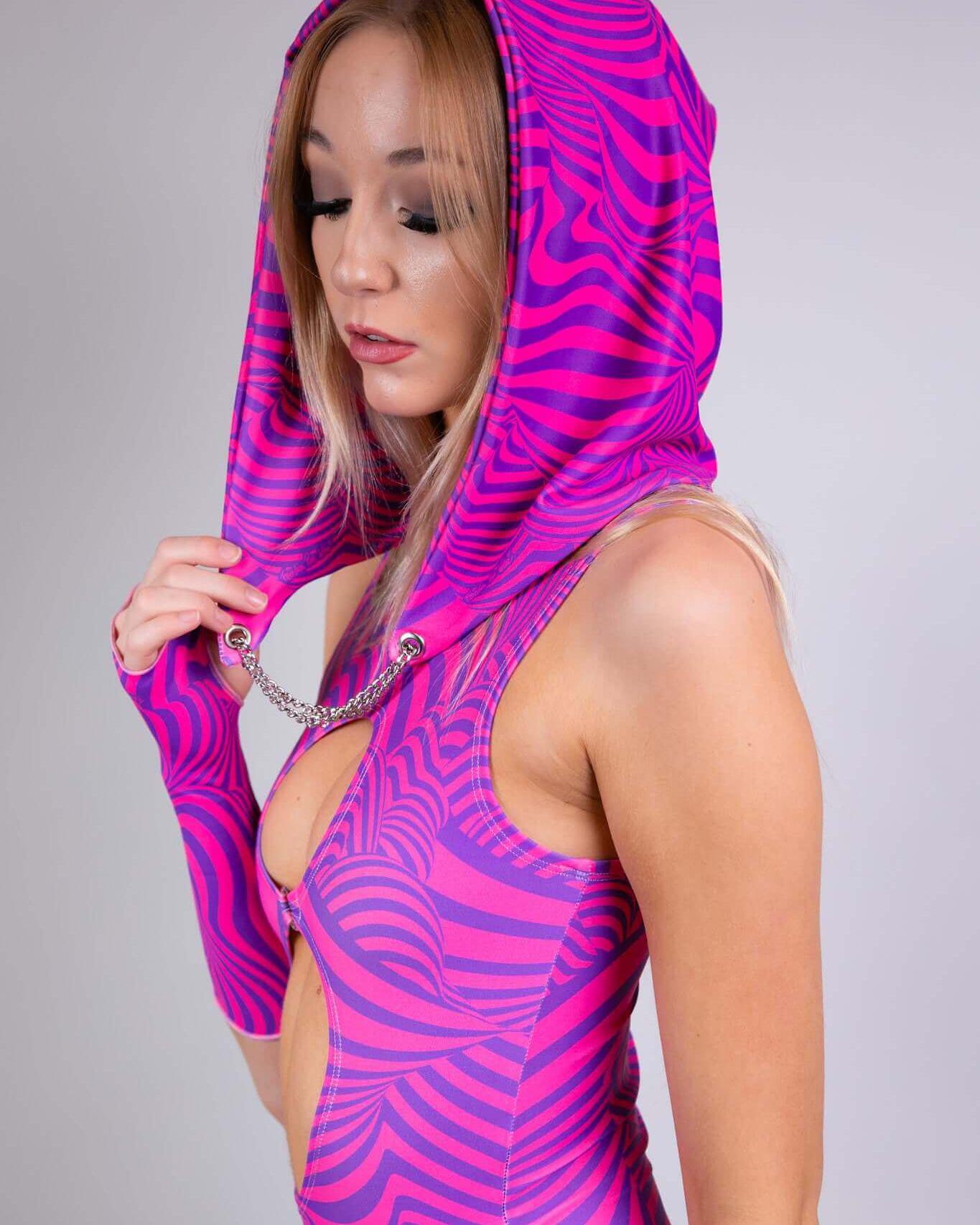 Model wearing a pink striped Cheshire Assassin Hood, showcasing its unique design and festival-ready style for rave outfits.