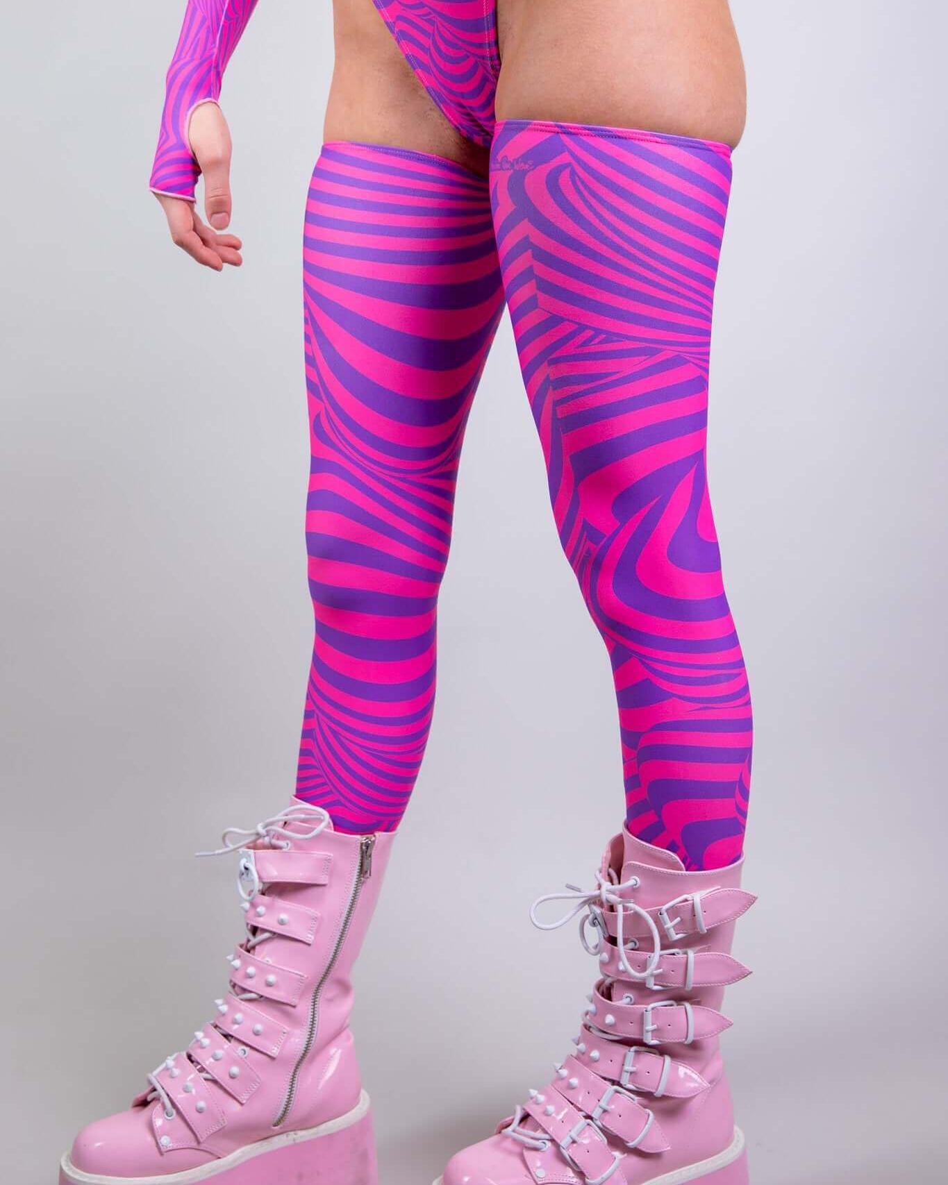 Pink zebra print Cheshire Leg Sleeves paired with stylish platform boots, perfect for rave outfits and dance events.