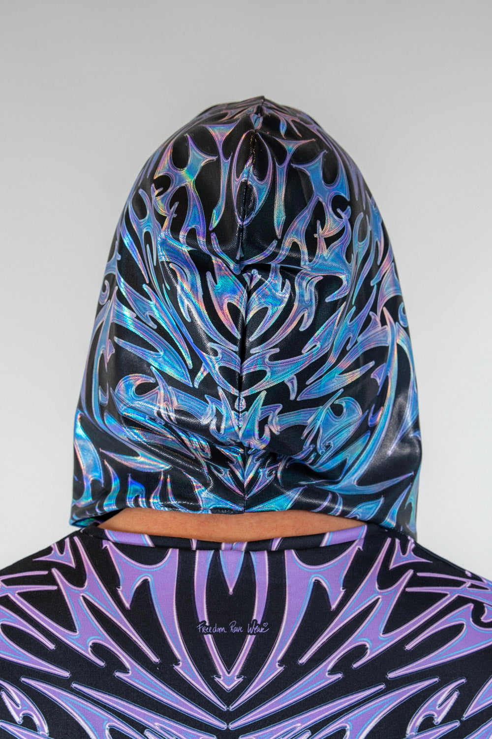 Back view of the Chromium Assassin Hood, showcasing its bold cyber sigalism pattern and relaxed hood fit.