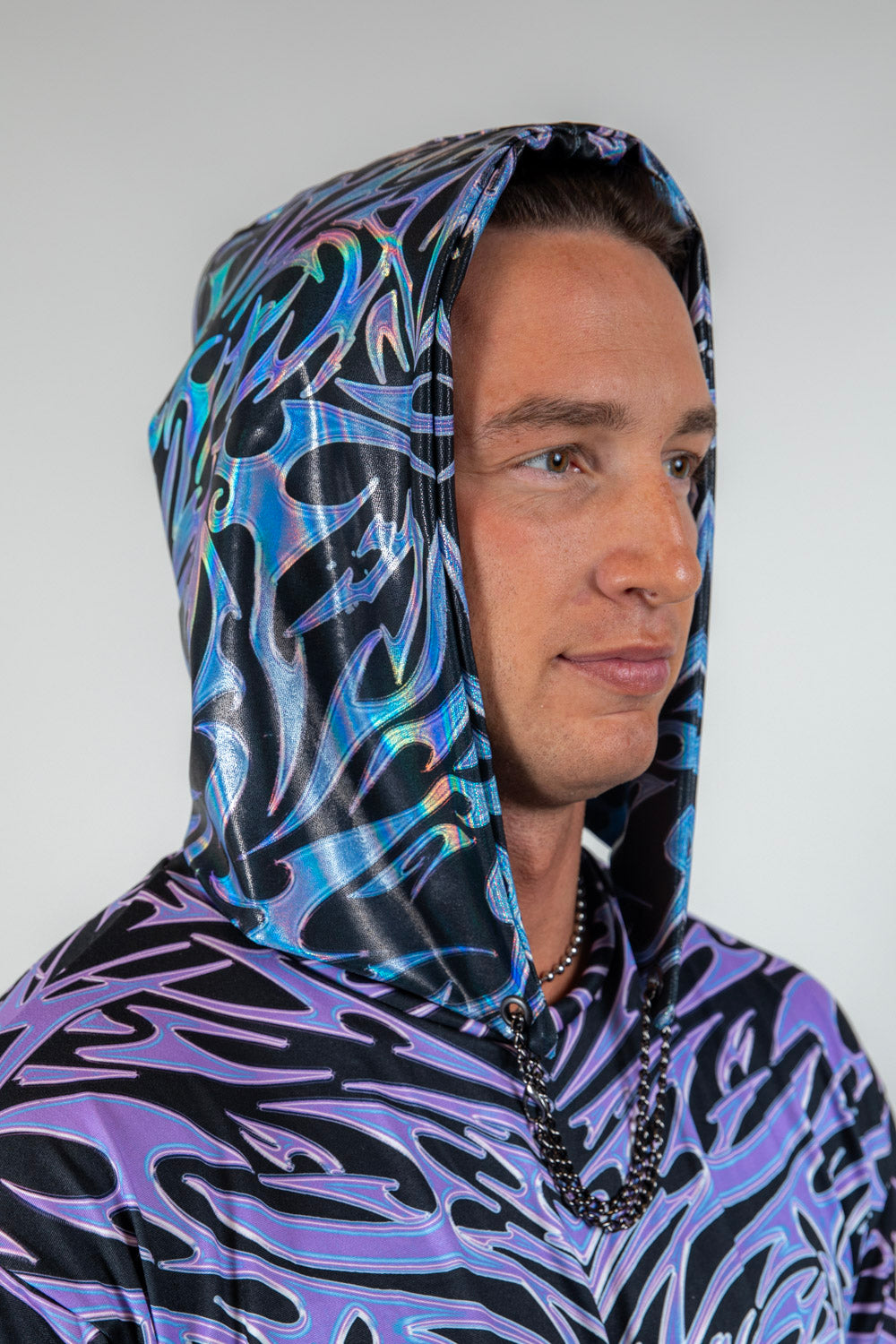 Model wearing the Chromium Assassin Hood, featuring a sleek cyber sigalism print and a futuristic hooded design.